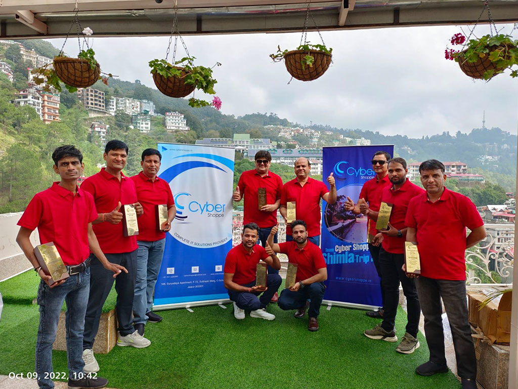 The team on the Shimla trip in 2022, holding awards for delivery excellence.